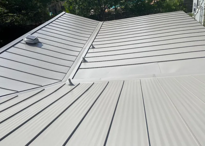 Solar attic fan installed on a metal roof for Roof Ventilation in Tupper Lake